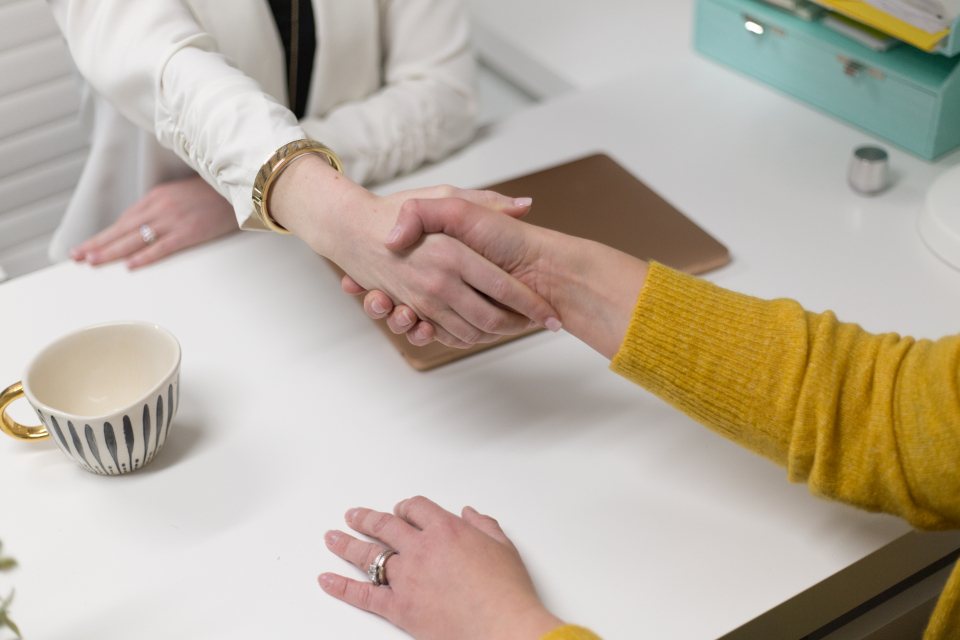 A handshake over a desk.